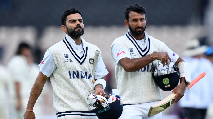 India's Virat Kohli (L) and India's Cheteshwar Pujara leave the pitch at the end of play on the fifth day of the ICC World Test Championship Final between New Zealand and India at the Ageas Bowl in Southampton, southwest England on June 22, 2021. - RESTRICTED TO EDITORIAL USE (Photo by Glyn KIRK / AFP) / RESTRICTED TO EDITORIAL USE (Photo by GLYN KIRK/AFP via Getty Images)