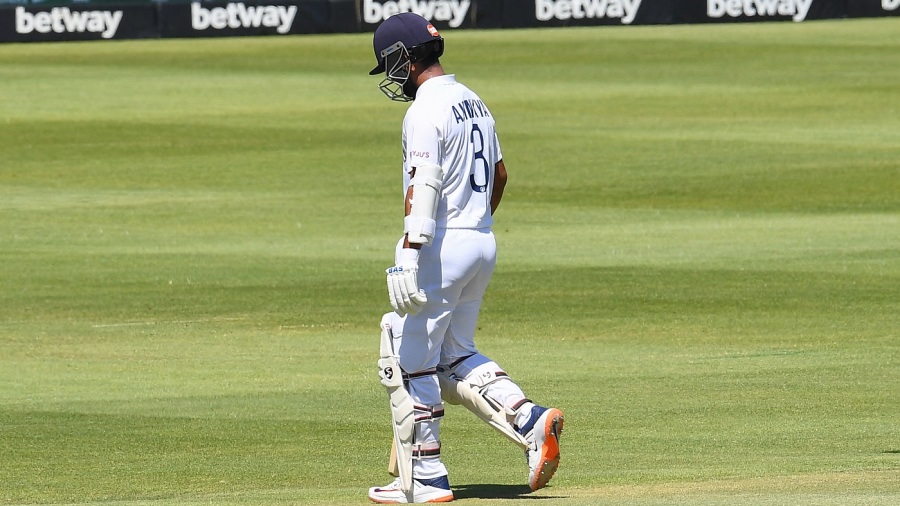 India's Ajinkya Rahane walks back to the pavilion after his dismissal during the third day of the third Test cricket match between South Africa and India at Newlands stadium in Cape Town on January 13, 2022. (Photo by RODGER BOSCH / AFP) (Photo by RODGER BOSCH/AFP via Getty Images)