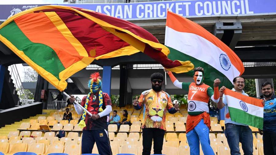 Sri Lankan and Indian cricket wave their country flags from the stands before the start of the Asia Cup 2023 super four one-day international (ODI) cricket match between Sri Lanka and India at the R. Premadasa Stadium in Colombo on September 12, 2023. (Photo by FAROOQ NAEEM / AFP) (Photo by FAROOQ NAEEM/AFP via Getty Images)