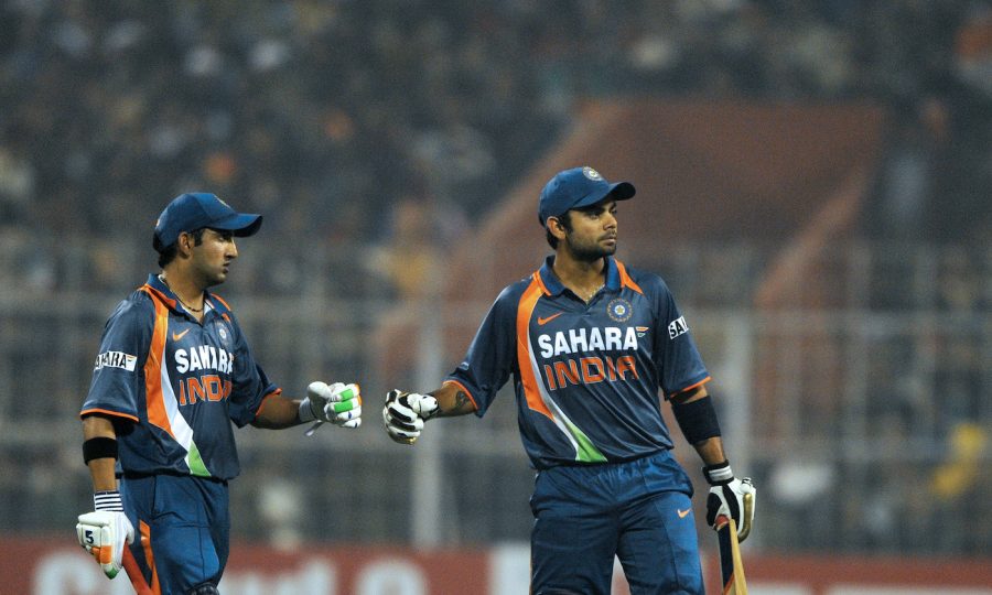 Indian cricketer Gautam Gambhir (L) congratulates teammate Virat Kohli after scoring a boundary during the fourth One Day International (ODI) cricket match between India and Sri Lanka at Eden Gardens Stadium in Kolkata on December 24, 2009.    India are 292 runs for the loss of three wickets after 45 overs chasing 316 runs to win.  AFP PHOTO/Deshakalyan CHOWDHURY (Photo credit should read DESHAKALYAN CHOWDHURY/AFP via Getty Images)